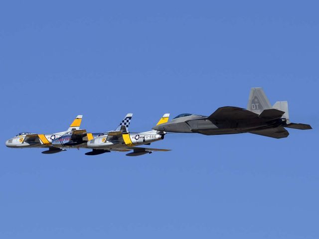 Lockheed F-22 Raptor (04-4068) - A Raptor flies in formation with three Sabres at the Air Force Heritage Conference.