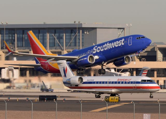 Canadair Regional Jet CRJ-200 (N423SW) - SW N8674B is taking off from 7L in the background. 