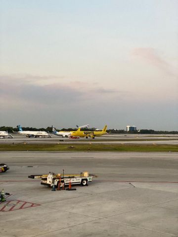 N2XXXJ — - JetBlue A320 rotating to the northeast in the background, Spirit A321 just arrived and 2 JetBlue A321s and Alaska 737 sharing Zulu remote parking