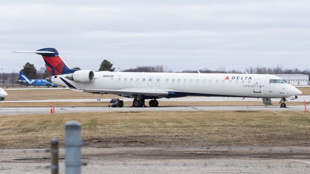 Canadair Regional Jet CRJ-900 (N800SK) - A Delta CRJ9 sits outside of the Delta Maintenance hangar getting a tire replaced.  1/14/23