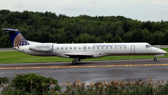 Embraer ERJ-145 (N21537) - Taxing by the ILS hold area for 24, one of the few remaining Continental painted aircraft. UPDATE: The aircraft was recently repainted into standard United Express livery.