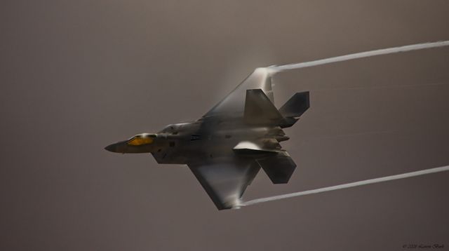 — — - F-22 maikng a high speed making at a drizzly MCAS Miramar Air Show in 2009