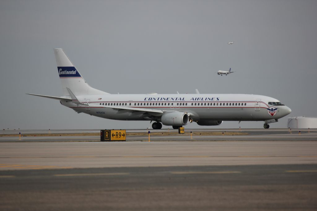 Boeing 737-900 (N75436) - 737 in retro Continental livery taking off to the east this morning (3-12-2012) on runway 8 at DIA.