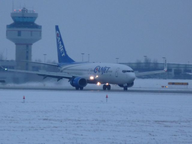 Boeing 737-800 (C-FTCZ) - landing on #07 from Mexico, control tower in background.