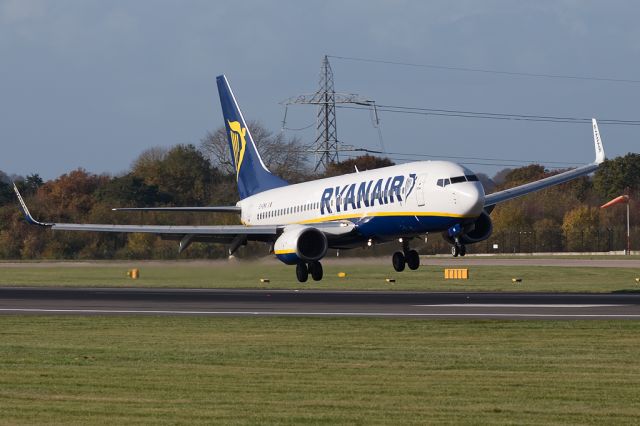 Boeing 737-800 (EI-EMA) - RYR3502 from Hamburg fighting the crosswind, shown by the windsock in the background, just before landing on 05R.