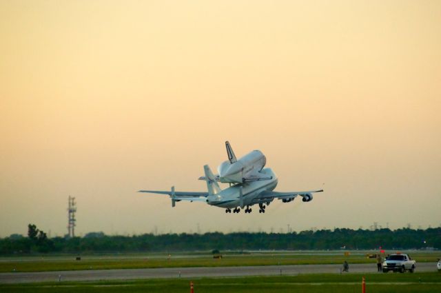 — — - Space Shuttle Endeavour departs Houston Ellington Field at sunrise on September 20, 2012