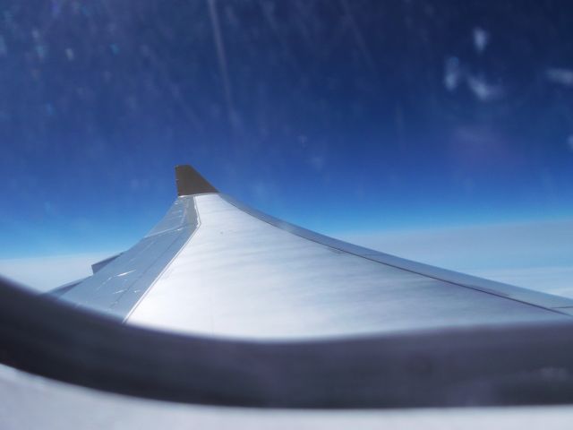 Airbus A330-200 (G-SMAN) - flying in economy over the Irish sea towards KSFB with slight turbulence and a scratched window