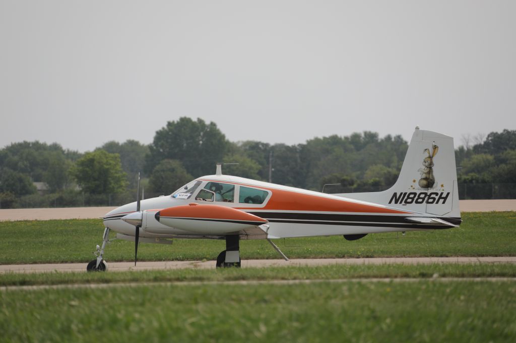 Cessna 310 (N1886H) - On flightline. Also, Blancolirio at the controls.