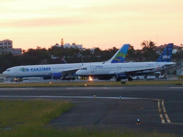 Airbus A320 — - Jet Blue A320 (taxiway D) and Air Caraibes A333 (taxiway C)waiting for backtrack  and take off runway 28.
