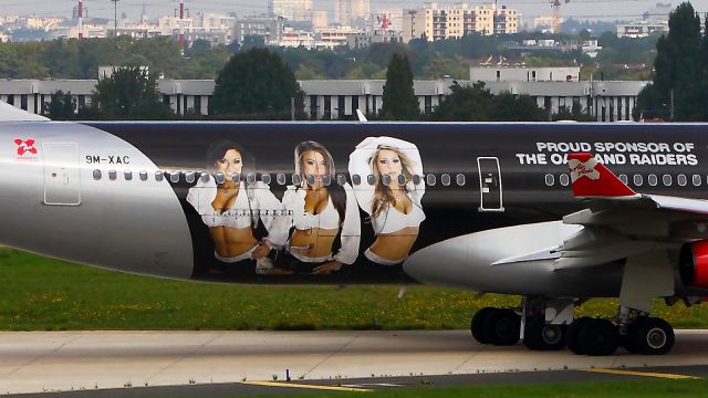 Airbus A340-300 (9M-XAC) - West Terminal. Livery"proud sponsor of oakland raiders"right side detail.