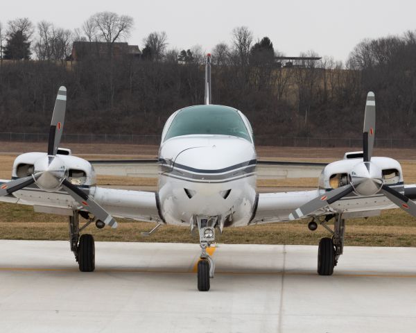 Beechcraft Baron (58) (N557CE) - A Beechcraft Baron 58 sits on the ramp at Butler County.