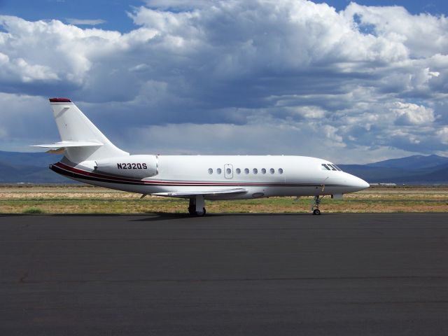 Dassault Falcon 2000 (N232QS) - Falcon on a cloudy August day with Taos ski area mountains about 15 miles away in the background.