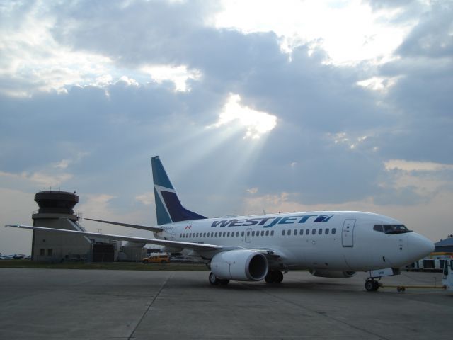 BOEING 737-600 (C-GBWS) - WestJet Boeing 737-600 awaiting pushback at Fort McMurray, Alberta, Canada, June 12, 2008.