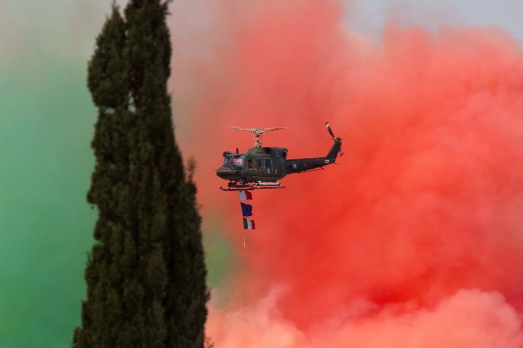 — — - Smoke from the Frecce Tricolori still on the runway.