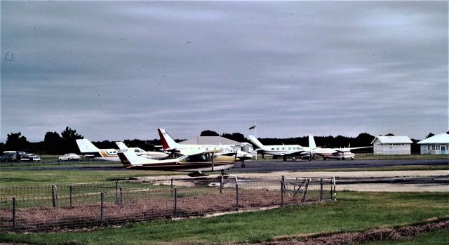 Cessna Skylane (VH-EIP) - A regular Visitor from NE Tasmania VH-EIP circa 1978. Air Tasmania Navajos and Executive Airlines Grand commander and C402 in the background. The pens in the foreground were for holding lambs pending shipment. Tens of thounsands of lambs were flown out of the Island in the 1960s and 70s, using DC3s DC4s Bristol freighters and carvairs.