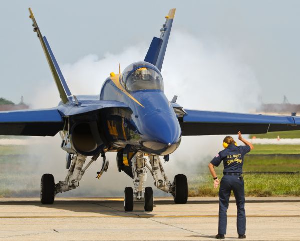 McDonnell Douglas FA-18 Hornet (16-3765) - Crew Chief Hanna Rains communicates with the pilot of Blue Angel #3, Capt. Brandon Cordill, through a series of sophisticated hand signals to check that all the flight surfaces are free and clear for the performance.