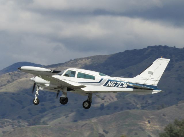 Cessna 310 (N67CM) - Taking off RWY 26L