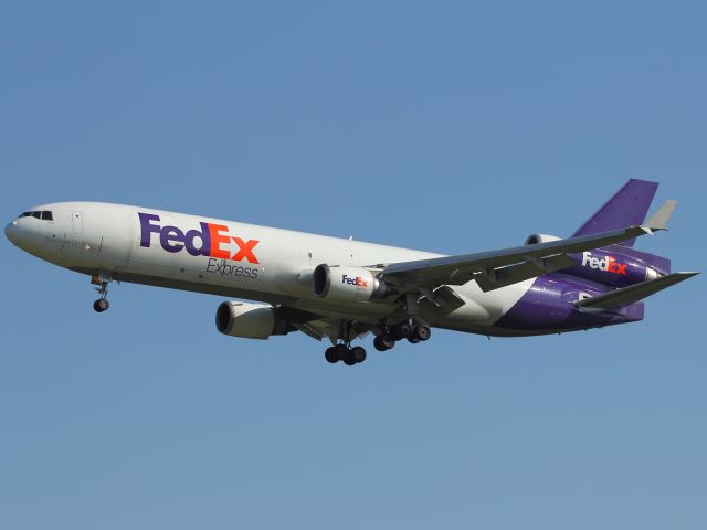 Boeing MD-11 (N591GT) - A Fed Ex approaches Stanstead Airport. Note the sensor on nose cone of aircraft.