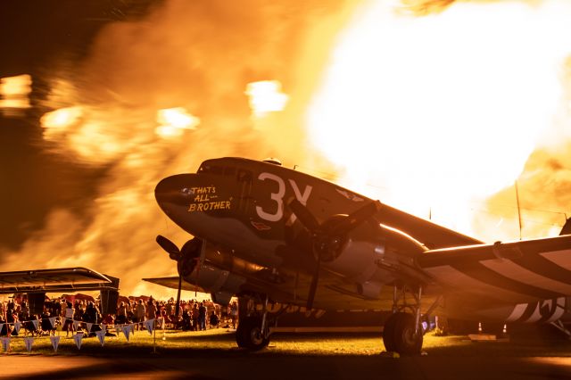 Douglas DC-3 (N47TB) - "That's All, Brother" basking in the heat during the night show at the 2019 EAA Airventure.