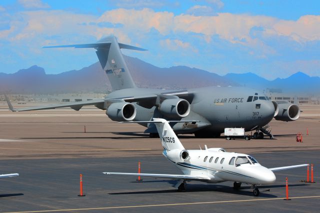 Cessna Citation CJ1 (N125CS) - Parked at Cutter Aviation in the shadow of USAF C-17.