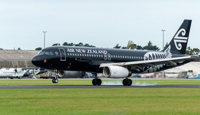 Airbus A320 (ZK-OAD) - ZK-OADs touch with terra firms spins the rubber up as it lands on Runway 29 in a moderate Nor-west wind. Taken with my Nikon AFS 300mm/f2.8 lens