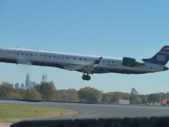 Canadair Challenger (N956LR) - Aluminum Overcast 11/8/2013 KCLT - Taxing to RWY 36R - N956LR departing.  I was taking a picture of the Charlotte Skyline from B17 when the CRL900 got in my way.