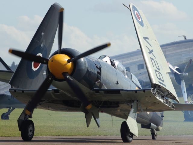 — — - An impressive and powerful looking aircraft. The Sea Fury taxies in after performing a final flypast at Flying Legends 2012, at Duxford Air Museum.