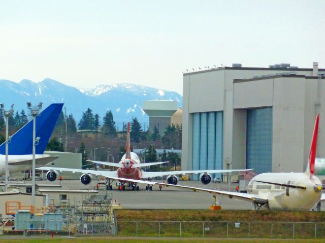 N6067E — - OLL OUT SERIES #8:  Boeing 747-8 Intercontinental RC001 Business Jet for undisclosed government  customer being pulled to its parking place in front of the paint Boeing hangar on 2-13-2011 roll-out day at Paine Field, Everett, Washington  ||||   Photo by Bruce McKinnon