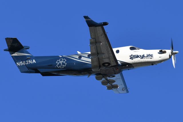 Pilatus PC-12 (N562NA) - Ascending from the airport. 