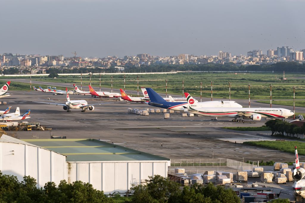 BOEING 777-300 (S2-AFO) - 16th Sept., 2016 : Overview of the apron from the north-easterly corner of the main airport in Bangladeshs capital city, Dhaka. All but one aircraft belongs to one of the five main Bangladeshi operators: Biman Bangladesh; Regent Airways; NovoAir; US-Bangla and Capital Cargo.