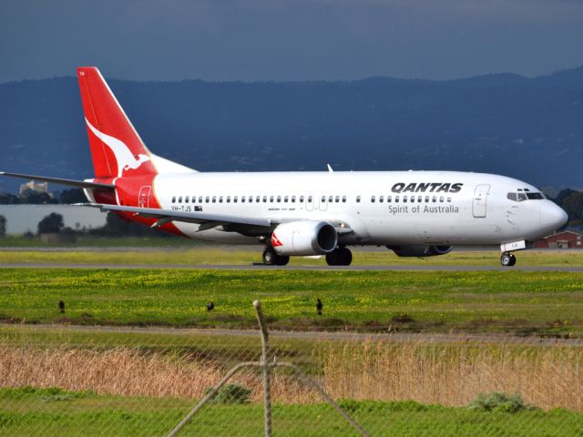 BOEING 737-400 (VH-TJS) - On taxi-way heading for take off on runway 05. Thursday 12th July 2012.