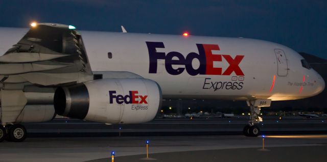 Boeing 757-200 (N905FD) - I was actually invited to walk along next to FDXs "Cassandra" (N905FD) as it moved south on Alpha for a last-full-minute-of-dusk departure on runway 34L.  As it taxied along at a pretty good clip in (almost) total darkness, I walked along the adjacent service road and snapped off four Speedlite 430EX flash shots.  This was click #2.  