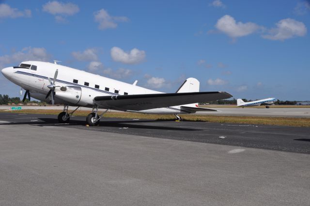 Douglas DC-3 (YV-2119) - DC3 Turbo prop with N271SE Taxing in the background at Opa Locka Arpt in Florida.