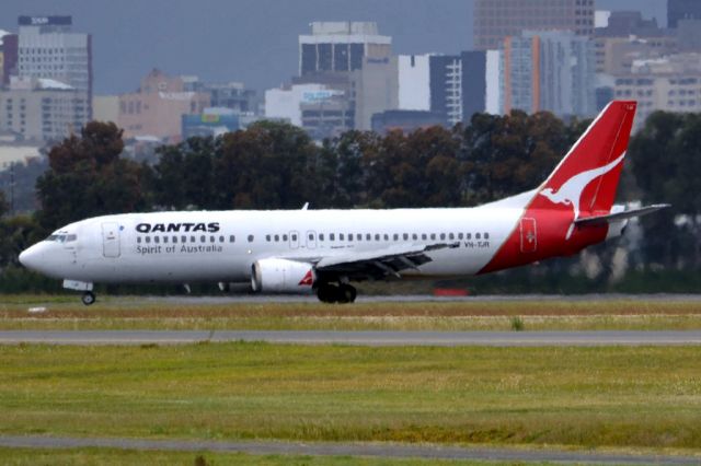 BOEING 737-400 (VH-TJR) - On taxi-way heading for Terminal 1, after landing on runway 23. Friday 5th October 2012.