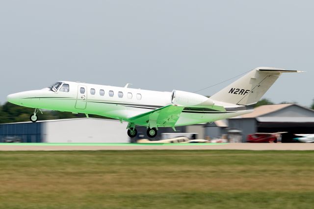 Cessna Citation CJ3 (N2RF) - The green dot on runway 27 reflects on the belly of this nice looking Citation as it departs to escape incoming severe weather.