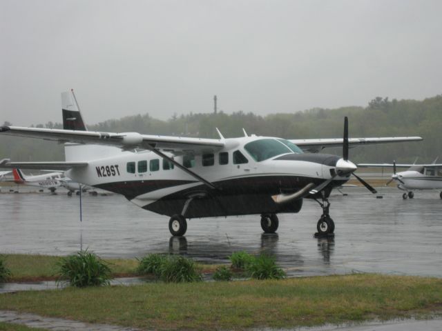 Cessna Caravan (N28ST) - Sitting on the ramp on a very rainy, foggy day after arriving this morning from Westminster, MD (KDMW). Oxford Hill LLC sold their Piper Malibu Matrix (N6087V) and bought this nice 2010 Caravan. If you view the image in "full" mode you can see the rain pouring down.