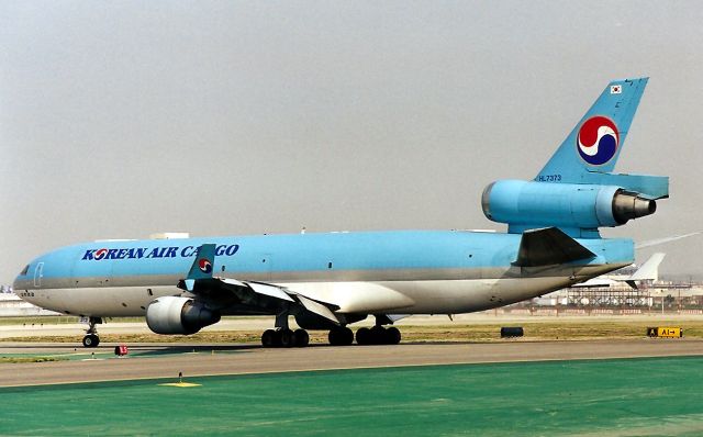 Boeing MD-11 (HL7373) - KLAX - Korean Air Cargo MD-11F at LAX holding short of 25 L on Nov 1998. This jet departed quickly - possibly headed for HKG. This jet written off in April 1999 at Soeul RSK departing for Shanghai.