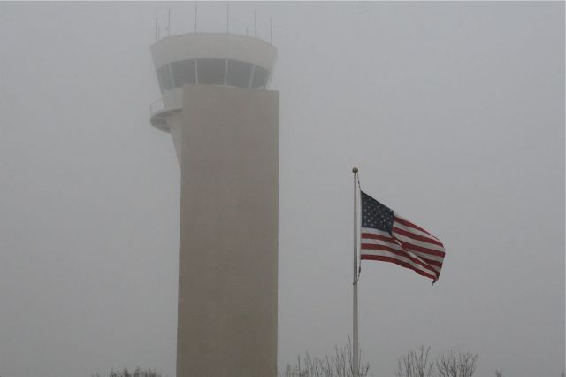 — — - American Flag in front of the KAFW Tower on a foggy morning  1-8-2012