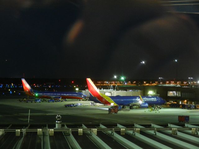 Boeing 737-700 (N850IV) - N850IV, A Southwest Airlines B737-700 Sits At The Gate, In The Distance A Southwest B737-800 Sits Parked At The Gate, In The Background Is A World Airways DC-10 Which Was Damaged Beyond Repair In 2009, She Is Now Used For Fire Training