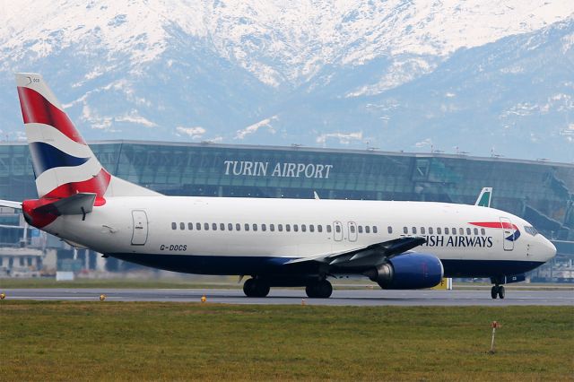 BOEING 737-400 (G-DOCS) - Lined up for takeoff with the Alps and the passenger terminal in the background.