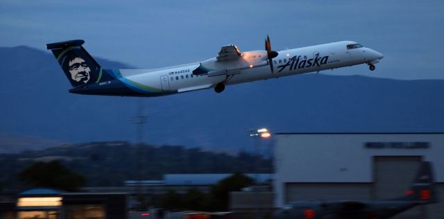 de Havilland Dash 8-400 (N445QX) - In the final few moments of dusk light, just before full darkness descends over Reno Tahoe International, QXEs N445QX is putting the wheels up into the wells as it climbs away from 34L at 8:30 PM to begin an evening flight to Seattle (KSEA).