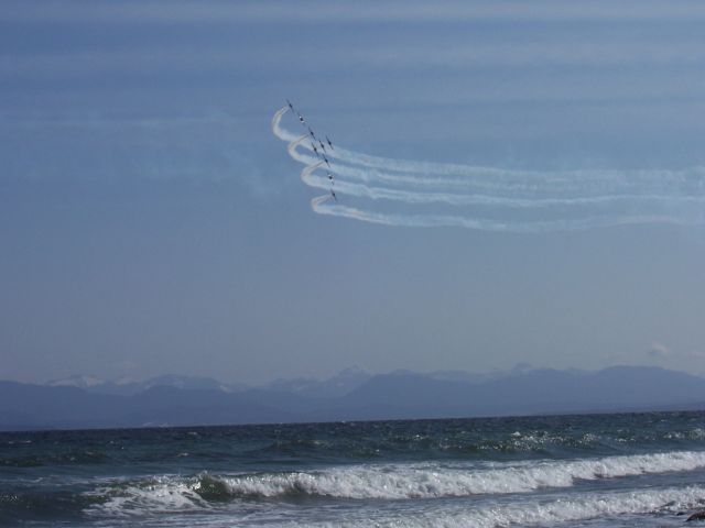 — — - "Air-Water-Fire essence of Life"  Canadian Snowbirds    9 Canadian Forces CT-114 Tutors  fly a "Vulcan formation"  off CFB Comox shore