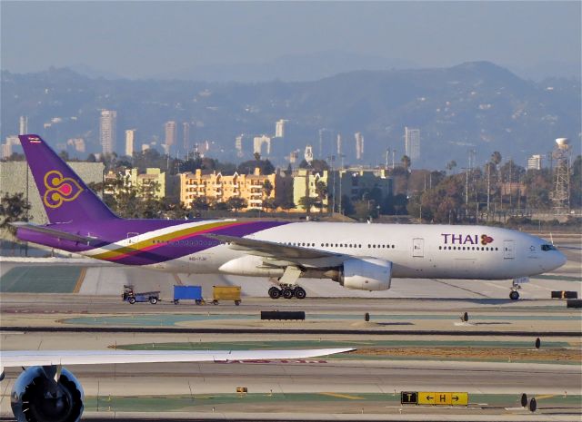 Boeing 777-200 (HS-TJR) - Photo framed  by wing of DLH 748  D-ABYP -10/21/14