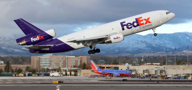 McDonnell Douglas DC-10 (N360FE) - As a few flakes of snow begin falling from a dark cloud, Fed Ex's "Annibel" (N360FE) is off 34L and on the climb out of RNO.