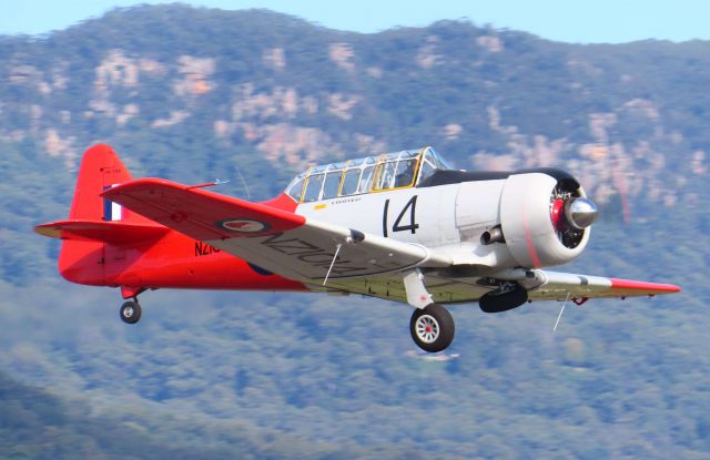 North American T-6 Texan (VH-TOA) - VH-TOA a North American T-6 Texan roars out of the beautiful Shellharbour airport for a short Joyflight with VH-EAF a Douglas DC-3.