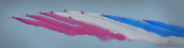 FUJI T1F — - The Royal Air Force Red Arrows perform a fly-by over Boston Harbor with their signature smoke trails during a recent performance.