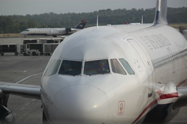 Airbus A320 (N658AW) - Full frontal view, including pilots as N658AW approaches the gate (B3) at CLT on 4/27/12
