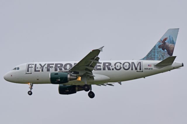 Airbus A319 (N954FR) - Frontier Airlines Airbus A319-122 newly revised livery featuring Mickey the Moose on the tail seen here on final approach to runway 1L at Milwaukee General Mitchell.