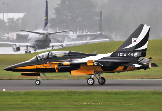 Saab 340 (001) - Foul weather all day at 2012 Farnborough International Airshow. This Republic of Korea Air Force Black Eagle demo was cut short and landed in heavy rain.