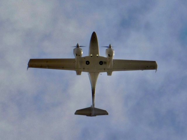 Diamond Twin Star (N449DS) - One of Delta State’s DA-42 planes flying over me at school